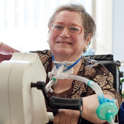 patient using passy muir valve with handbike