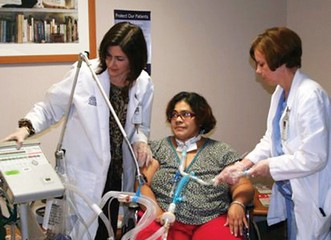 Two caregivers with ventilator patient